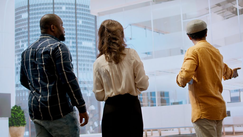 Corporate clients and a real estate agent negotiating a leasing contract